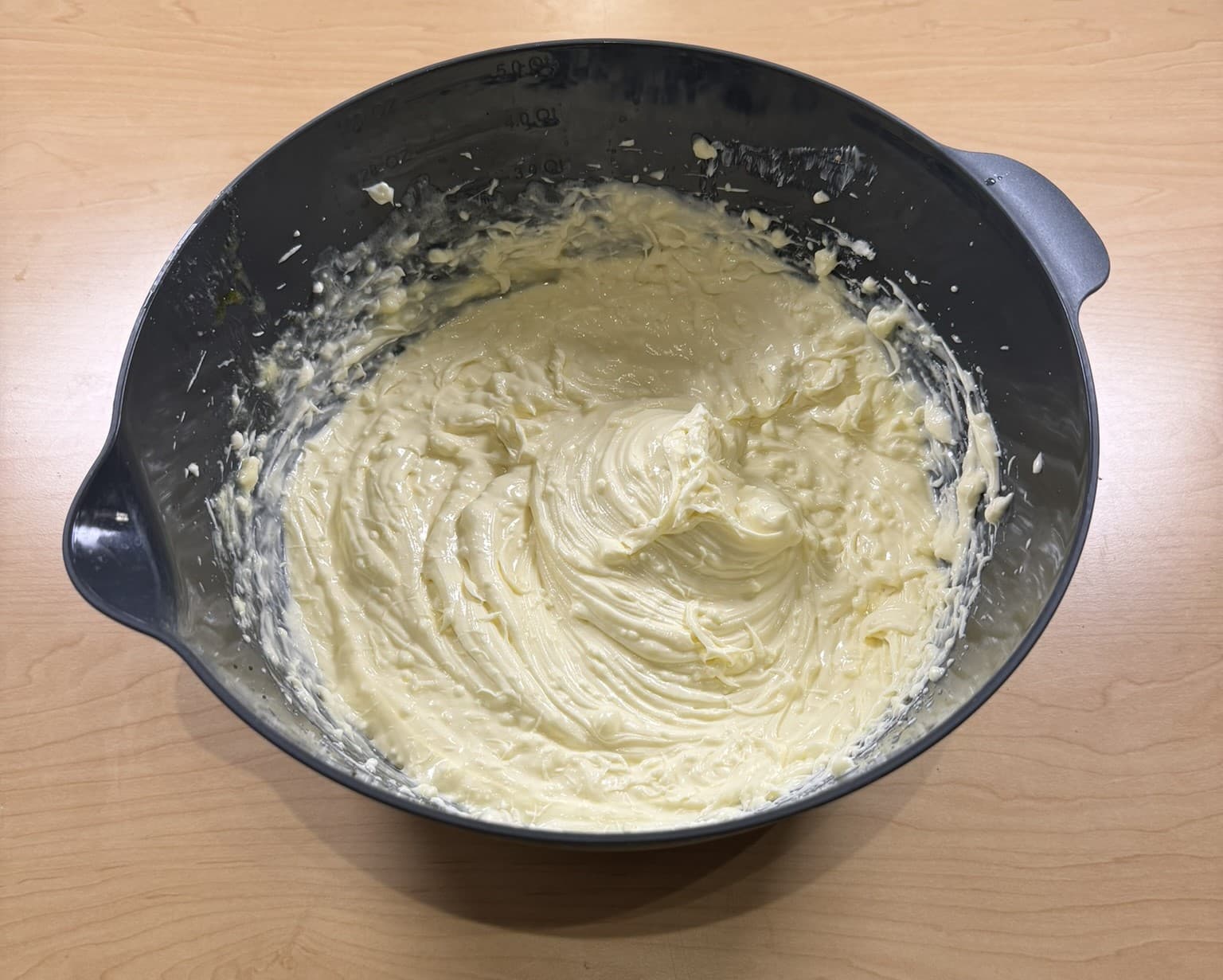 Mixing eggs and cream cheese